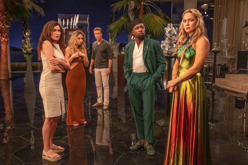 Official film still — ensemble in the Glass Onion atrium for Glass Onion: A Knives Out Mystery