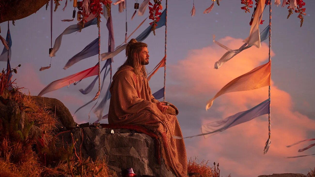 Official Disney film still — Thor among the battle flags for Thor: Love and Thunder